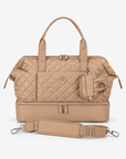 Beige quilted Weekender Bag with Mini Tote attached and detachable shoulder strap arranged in front