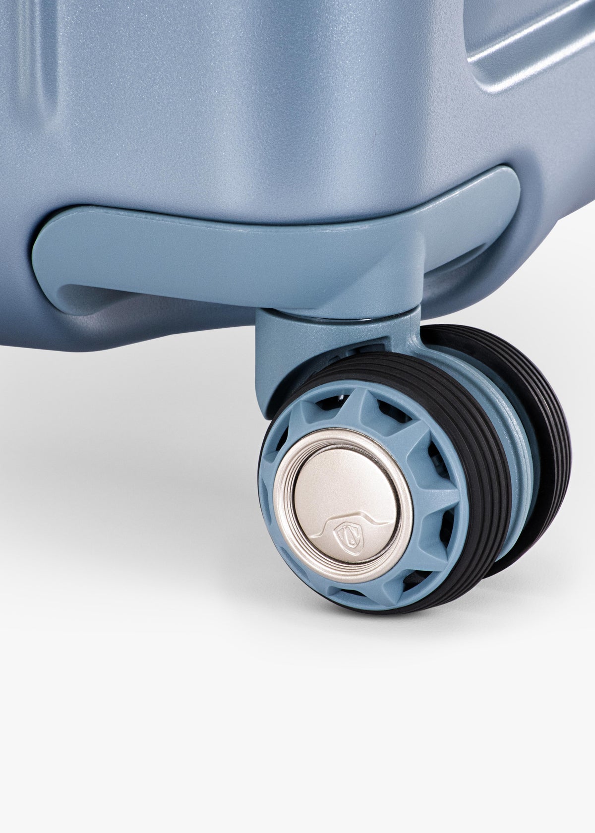 Close-up of a spinner wheel on the Teal Ultimax II 25-inch checked suitcase.