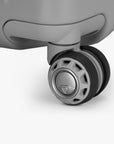 Close-up of a spinner wheel on the Gray Ultimax II 25-inch checked suitcase.
