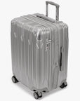 Angled view of a silver Bell Weather medium checked suitcase with its expansion section open.