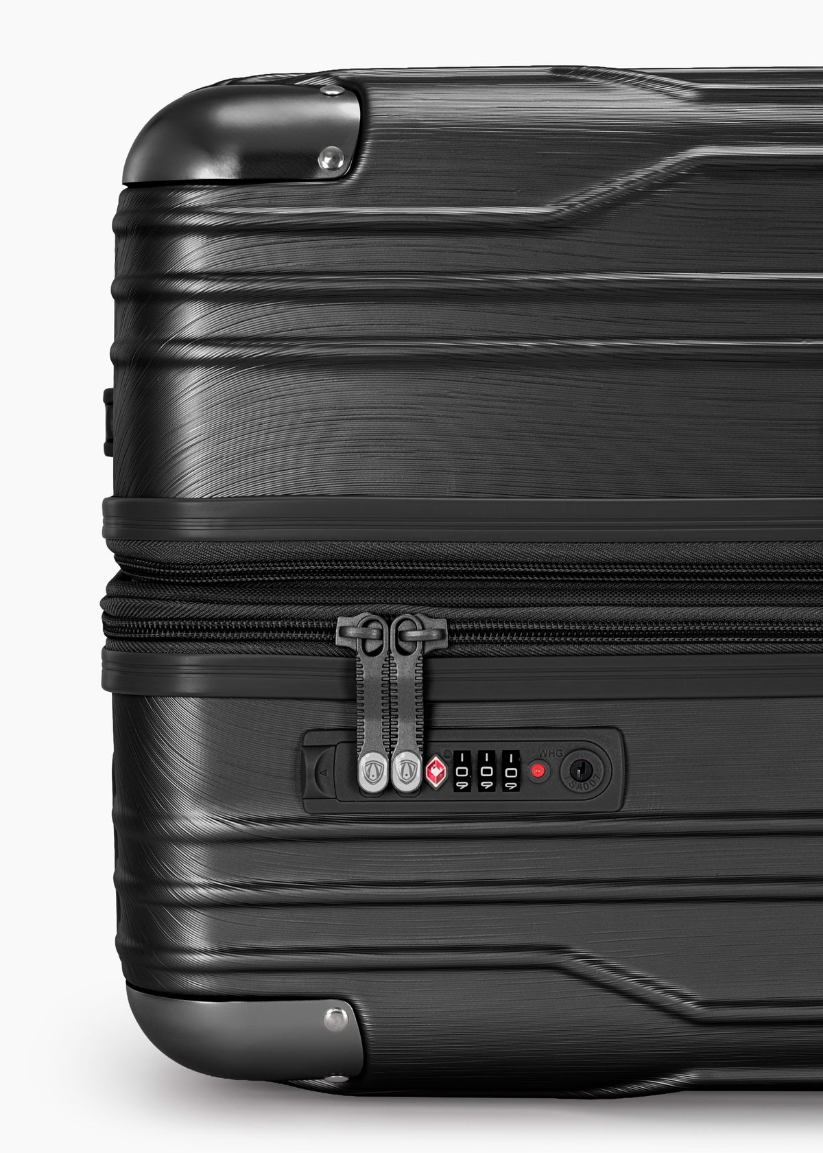 Close-up of the combination lock and zipper pulls on a black Bell Weather carry-on.