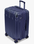 Angled view of a navy Bell Weather medium checked suitcase with its expansion section open.