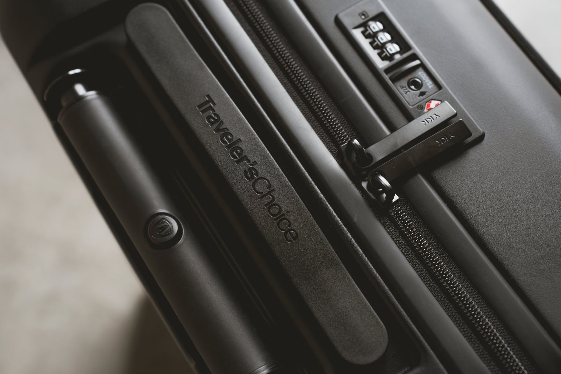Close-up of the TSA lock and zipper on a Traveler's Choice hardside case