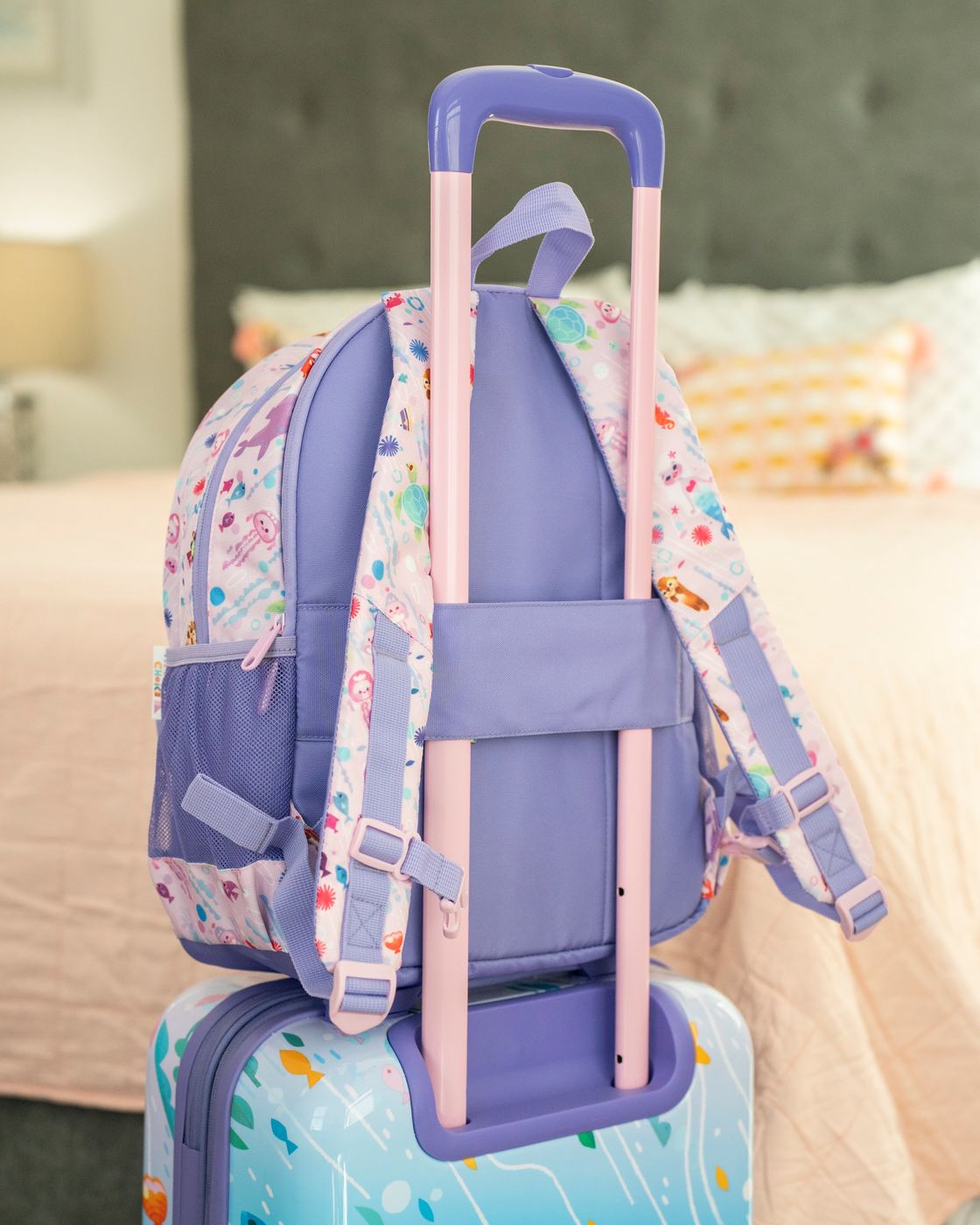 The Ocean backpack's trolley sleeve over the handle of the Ocean carry-on.