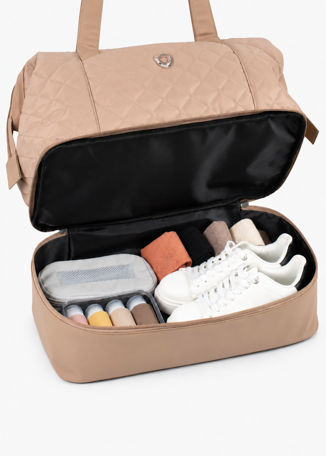 Beige Weekender Bag with the lower compartment open and packed with travel items
