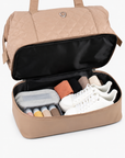 Beige Weekender Bag with the lower compartment open and packed with travel items