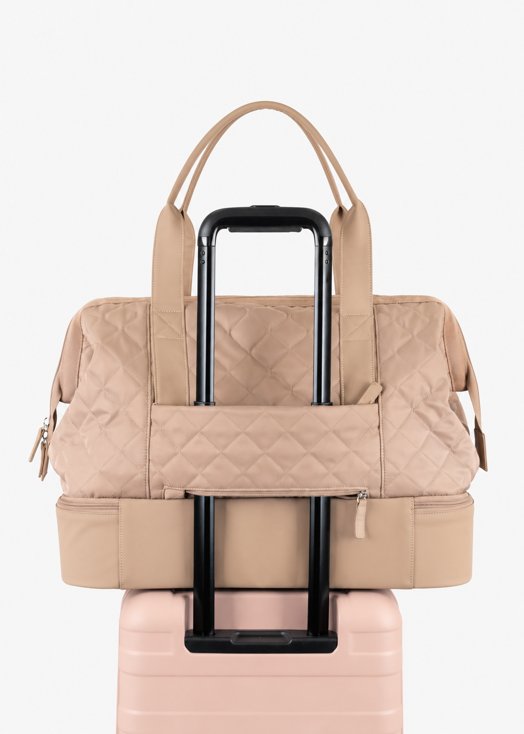 Rear luggage loop of the beige Weekender Bag around a suitcase handle