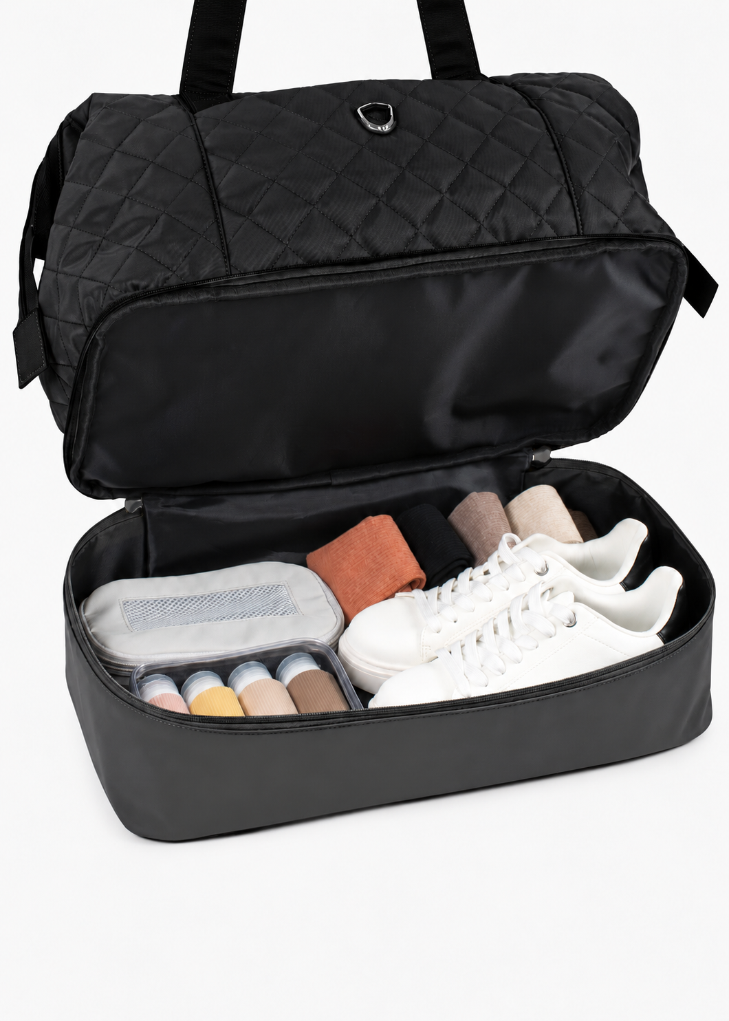 Black Weekender Bag with the lower compartment open and packed with travel items