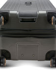 An image of the bottom of the gray trunk. It shows the wheels with a bottom handle for easy gripping off the carousel.