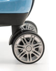 An image of a teal luggage and its silver wheels.
